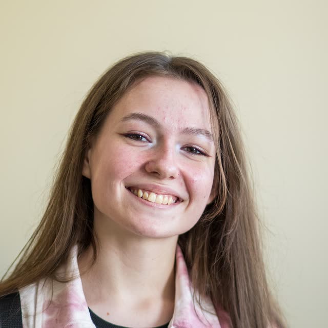 A smiling girl in a head-and-shoulders portrait