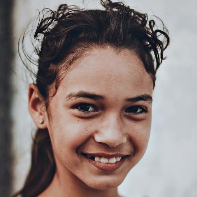 A smiling girl in a head-and-shoulders portrait