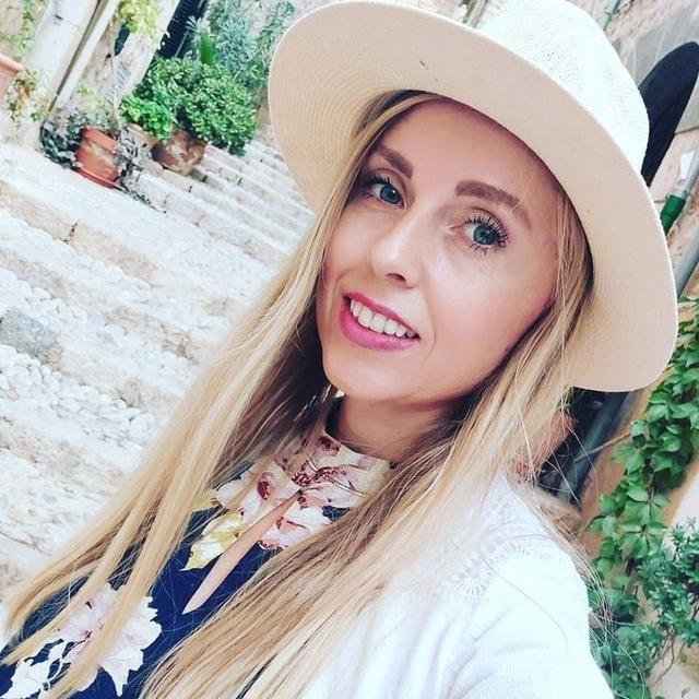 Lucie Trubak, founder of Life Skills Labs, wearing a cream hat and a floral top